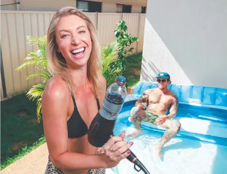  ?? Picture: GLENN CAMPBELL ?? Amanda Pernechele had to “MacGyver” up her hair dryer to inflate her fiance Rhys Jarrett's new pool