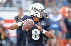  ??  ?? UCF quarterbac­k Darriel Mack Jr. looks to pass against Memphis during the AAC title game Saturday in Orlando, Fla. REINHOLD MATAY/USA TODAY SPORTS