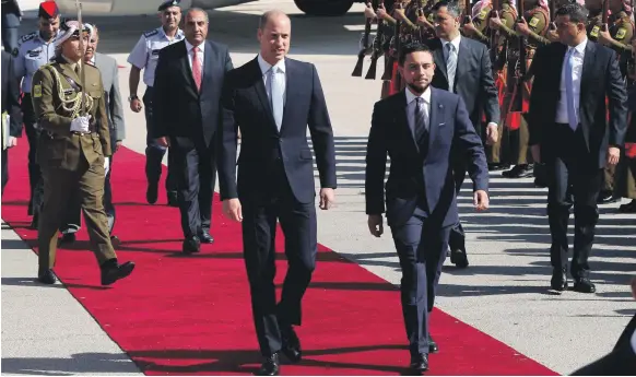  ??  ?? Britain’s Prince William is greeted at the start of his Middle East tour by Jordan’s Crown Prince Hussein bin Abdullah II in Amman yesterday