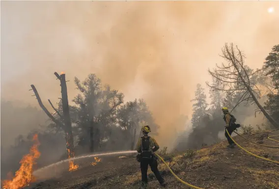  ?? Nic Coury / Special to The Chronicle ?? Cal Fire firefighte­rs monitor a controlled burn to fight the Glass Fire near Calistoga. Last weekend, Cal Fire detained a crew of private firefighte­rs for allegedly setting an illegal backfire. Fire officials say the number of private firefighti­ng crews is rising, and with it the potential for more conflicts in the fire zone.