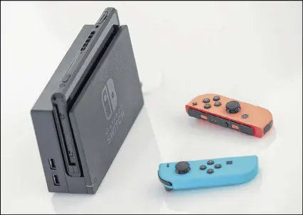  ?? DREW ANGERER / GETTY IMAGES ?? Nintendo is forecastin­g first-month sales of 2 million units of the Switch, a $300 hybrid game machine that works as both a console at home and a tablet on the go.