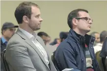  ?? CAMERON/ POSTMEDIA NEWS ELIZABETH ?? Jean-Christophe De Le Rue and Michael Van Hemmen of Uber listen to city transport committee members at a public meeting Thursday.