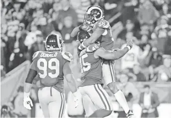  ?? GARY A. VASQUEZ/USA TODAY SPORTS ?? Rams linebacker Dante Fowler (56) celebrates with linebacker Obo Okoronkwo and defensive tackle Aaron Donald after a sack.