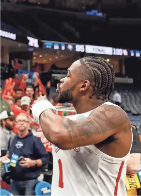  ?? CHRIS DAY/THE COMMERCIAL APPEAL ?? Houston’s Jamal Shead celebrates with Houston fans after Houston defeated Texas A&M 100-95 in overtime in the second round of the 2024 NCAA Tournament at Fedexforum in Memphis on Sunday.