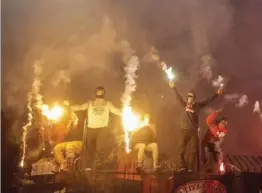  ??  ?? In this photo taken on Friday, December 1, 2017, Russian football fans of Spartak team burn flares during a Russian Premier League Championsh­ip soccer match between Arsenal Tula and Spartak Moscow in Tula, about 200 kilometers south of Moscow. Photo: AP