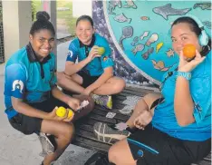  ??  ?? HEALTHY CHOICE: Tagai State College students (from left) Moana Ahwang, Rayna Laifoo, Kate Nicholls enjoying some fruit.