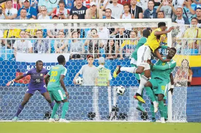  ??  ?? Above: Colombia’s Yerry Mina scores the only goal against Senegal during their World Cup Group H match in Samara, Russia, yesterday. Left: Poland’s
Jan Bednarek celebrates scoring against Japan in Volgograd. — Reuters