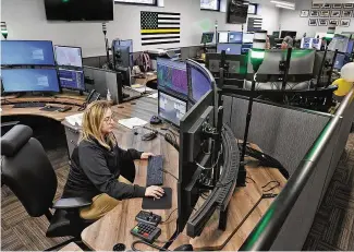  ?? BILL LACKEY PHOTOS / STAFF ?? Clark County dispatcher Alexandra Rollins-gonzalez works in the new combined Clark County Dispatch Center on Tuesday.