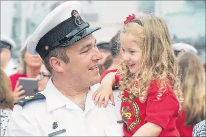  ?? CP PHOTO/ANDREW VAUGHAN ?? Master Seaman Scott Hickman holds his three-year-old daughter, Lila, as HMCS St. John’s returns to Halifax on Monday. The ship and crew were on deployment on Op REASSURANC­E, Canada’s contributi­on to NATO assurance measures for eastern Europe.