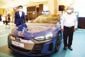  ?? ?? PGA Cars Planning Director Christophe­r Chan (left) and Transporta­tion Secretary Jaime Bautista present the Audi e-tron GT during the launch of Uptown Mall’s charging station.