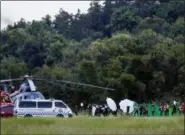  ?? VINCENT THIAN - THE ASSOCIATED PRESS ?? An emergency team rushes to a helicopter believed to be carrying one of the rescued boys from the flooded cave in Mae Sai as divers continue to extract some of the 12 boys and their coach trapped at Tham Luang cave in the Mae Sai district of Chiang Rai province, northern Thailand, Tuesday. Thai Navy SEALs say all 12 boys and their coach were rescued from the cave, ending an ordeal that lasted more than 2 weeks.