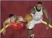  ?? TONY DEJAK — THE ASSOCIATED PRESS ?? LeBron James and the Rockets’ Gerald Green battle for a loose ball on Feb. 3 at Quicken Loans Arena.