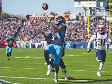  ?? AP PHOTO/AUSTIN ANTHONY ?? Tennessee Titans wide receiver Corey Davis catches a 23-yard touchdown pass during the first quarter of his team’s 34-10 win over the New England Patriots on Sunday in Nashville.