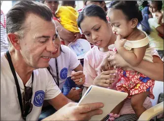  ??  ?? Duncan Bannatyne with little Xia Dumosmog on screening day during Operation Smile’s 2018 mission