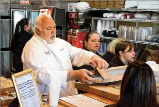  ??  ?? Straight out of New York, Fini’s Pizzeria owner Massimo Fini (front left) worked at his father’s New York pizzerias as a teenager after moving to the U.S. from Italy at age 10.