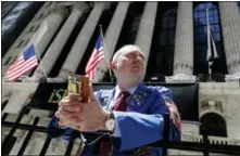  ?? KATHY WILLENS — THE ASSOCIATED PRESS FILE ?? Vincent Pepe enjoys some fresh air outside the New York Stock Exchange where he works trading cotton shares for VLM Commoditie­s in the Financial District in New York.