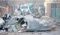  ?? ?? A Ukrainian soldier inspects aircraft wreckage in Kyiv.