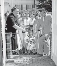  ?? THE COMMERCIAL APPEAL ?? Mrs. Boyd Arthur, president of the Germantown Women’s Club, proudly helped Hugh S. Ford, Germantown city manager, cut the ribbon at the official opening of the Germantown Community Library on June 28, 1954.