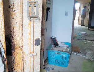  ?? Photos / Iris Riddell ?? Clockwise from top left: checking those radiation levels; an abandoned bathroom in Fukushima; the front doors of a nursing home; deserted office space.