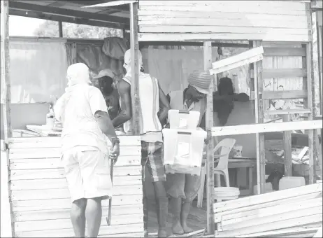  ?? (Photo by Keno George) ?? CH&PA workers removing household items from a home during the demolition exercise.