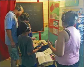  ?? TAWANA ROBERTS — THE NEWS-HERALD ?? Visitors tour The Compassion Experience at Kirtland Christian Fellowship on Aug. 18.