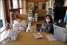  ?? COURTESY PHOTO ?? Administat­ive coordinato­r Valorie Mondragón sits ready to give out masks and hand sanitizer at the Taos Civic Center in December of 2020. The town of Taos spent a portion of its CARES funding to help provide sanitizer and PPE for locals businesses and residents.