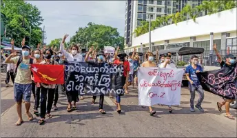  ?? — AFP photo ?? Protesters hold banners during a demonstrat­ion against the military coup in Yangon.