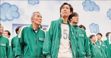  ?? Noh Juhan / Associated Press ?? Lee Jung-jae, center, starred in the Korean series “Squid Game,” which became Netflix’s most-watched show in 90 countries. Lee’s film “Hunt” is premiering in Cannes.