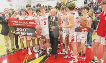  ?? Peter Wallace/For Hearst Connecticu­t Media ?? After celebratin­g their BL Tournament championsh­ip win over crosstown rival Litchfield, Wamogo’s Warriors found plenty of time to celebrate Coach Gregg Hunt’s 500th career win.