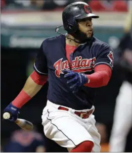  ?? TONY DEJAK — THE ASSOCIATED PRESS ?? The Indians’ Carlos Santana hits an RBI single in the eighth inning.