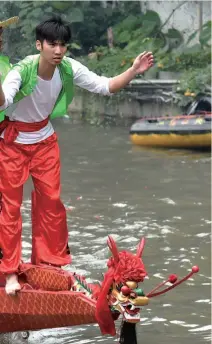  ??  ?? 广州天河区深涌沿岸村­民举行特色民俗活动——“龙船招景”，通过划龙舟的方式迎接­端午节的到来