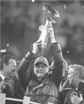  ?? MARK J. REBILAS/USA TODAY SPORTS ?? Owner Paul Allen held up up the Vince Lombardi Trophy after the Seahawks won Super Bowl XLVIII against the Broncos in 2014.