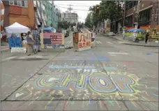  ?? AP PHOTO/TED S. WARREN ?? A sign on the street reads “Welcome to the CHOP,” on Saturday inside what has been named the Capitol Hill Occupied Protest zone in Seattle.