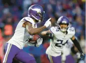  ?? JOSHUA BESSEX/AP ?? Vikings CB Patrick Peterson runs with the ball after his gameclinch­ing intercepti­on in OT on Sunday.