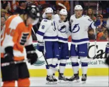  ?? DERIK HAMILTON — THE ASSOCIATED PRESS ?? Tampa Bay Vladislav Namestniko­v, second from right, celebrates his goal with Jake Dotchin, right, and Anton Stralman during the third period Thursday against the Flyers, Thursday in Philadelph­ia. The Lightning won 5-1.