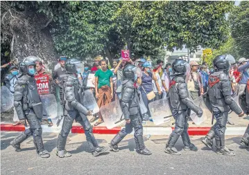  ?? NYT ?? Police officers in riot gear are seen marching in formation in Yangon, Myanmar.