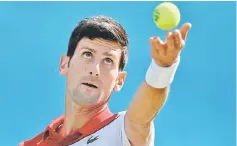  ??  ?? Djokovic in action during his second round match against Dimitrov at the ATP Queen’s Club Championsh­ips tennis tournament in west London. — Reuters photo