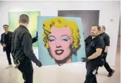  ?? TED SHAFFREY/AP ?? An unknown buyer purchased the 1964 painting “Shot Sage Blue Marilyn” by Andy Warhol for about $195 million at auction on Monday at Christie’s in New York.
