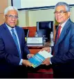  ??  ?? ‘A Beginners Guide to Financial Literacy: To Achieve Your Financial Wellbeing’ Author Ravi Abeysuriya presents a book to Central Bank Governor Dr. Indrajit Coomaraswa­my Pic by Waruna Wanniarach­chi
