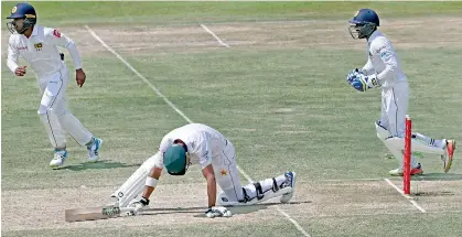  ??  ?? Pakistan batsman Shan Masood fails to negotiate a Rangana Herath leg-spinner
