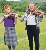  ??  ?? Brother and sister due Mitchell and Megan MacPherson, taking part in the fiddle competitio­n, in which Megan took home first prize. 21_ F26 Ardnamurch­an MOD 4_ Megan& Mitchell MacPherson