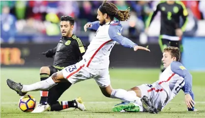  ??  ?? COLUMBUS: Carlos Vela #11 of Mexico battles for the ball with Jermaine Jones #13 and Matt Besler #5 of the United States in the second half during the FIFA 2018 World Cup Qualifier at MAPFRE Stadium on Friday in Columbus, Ohio. — AFP