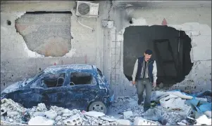  ?? AP PHOTO ?? In this Monday, April 16, 2018 photo, man walks just meters away from where the alleged chemical weapons attack occurred in the town of Douma, the site of a suspected chemical weapons attack, near Damascus, Syria.