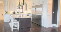  ??  ?? The Winchells’ modern kitchen includes design elements, like the raised panel cabinetry, that are in keeping with its heritage.