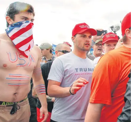  ??  ?? Pro-President Trump and anti-Trump protesters scuffle during a rally in Huntington Beach, California.