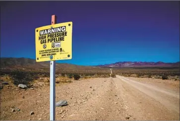  ?? Brian van der Brug Los Angeles Times ?? A WARNING SIGN at the site of the Southern California Gas Co. pipeline explosion near Newberry Springs on Oct. 1, 2017. Nobody was injured in the blast, which went largely unnoticed outside of the energy industry.