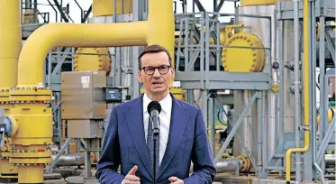  ?? | AFP ?? POLISH Prime Minister Mateusz Morawiecki speaks to the media on Russia halting the country’s gas supply at a gas transmissi­on point in Rembelszcz­yzna near Warsaw, yesterday.