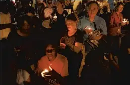  ?? MIKE STOCKER/STAFF PHOTOGRAPH­ER ?? Parents, teachers and students gathered at Horizon Elementary School in Sunrise for a candleligh­t vigil, part of a series of vigils statewide on Monday night.