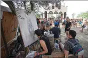  ?? ELIZA GREEN / THE CALIFORNIA­N ?? Artist Hans Valor paints near the Grand Antique stage at last weekend’s Lightning in a Bottle music festival at Buena Vista Aquatic Recreation­al Area.