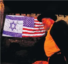  ?? AHMAD GHARABLI / AFP / GETTY IMAGES ?? The Jerusalem municipali­ty projected giant U.S. and Israeli flags onto the walls of the Old City on Wednesday.